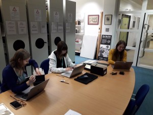 Interns working on the Elder Dempster: Captain Morgan Archive Collection.